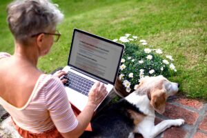 woman on laptop with dog